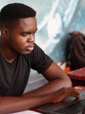 Student using a computer – courtesy of Kojo Kwarteng, Unsplash