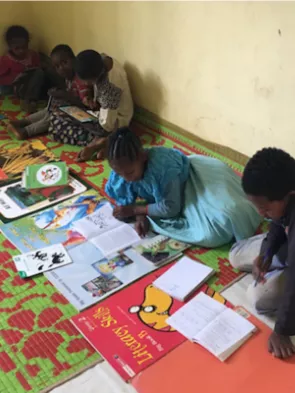 Children sitting on the floor and reading books